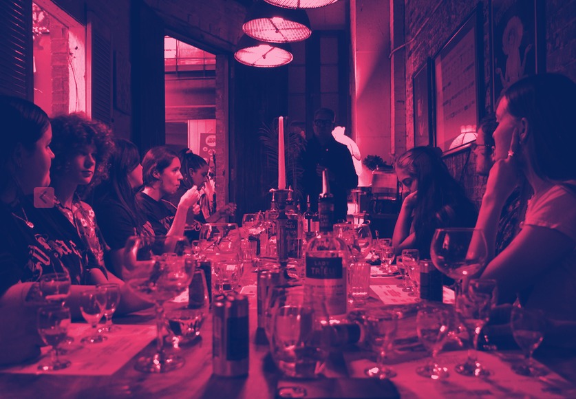 Guests at a long tasting table, duotone
